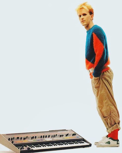 Howard Jones tilt pose over his keyboard